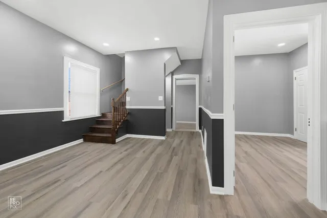 a view of empty room with wooden floor