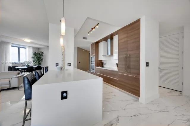 a large white kitchen with a large window