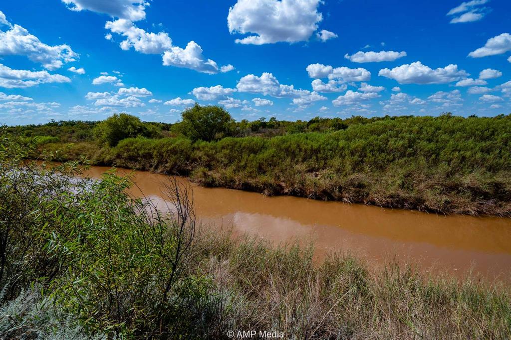 a view of a lake with a yard