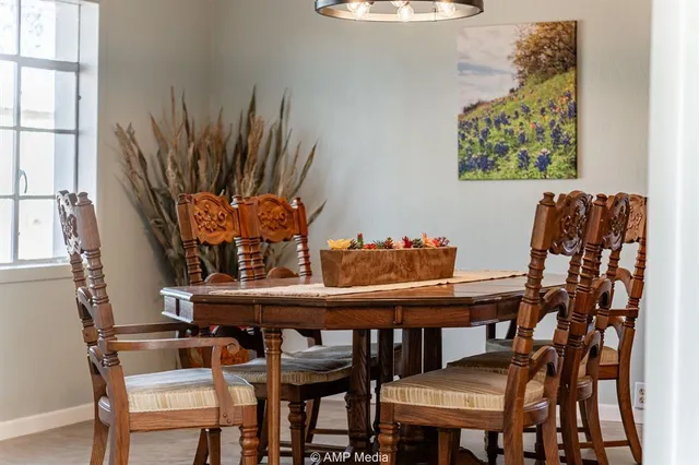 a view of a dining room with furniture and a potted plant