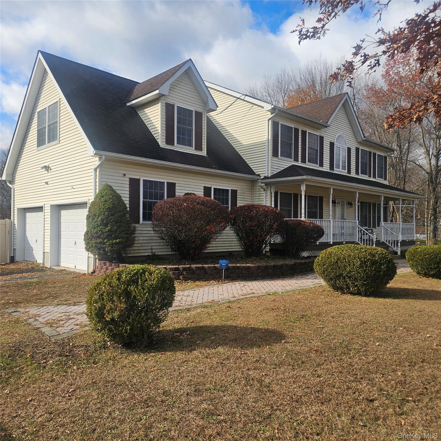 235 Maples Road Middletown, NY 10940 - Photo 2 of 34 View of front of property featuring a front lawn, a porch, a garage, and roof with shingles