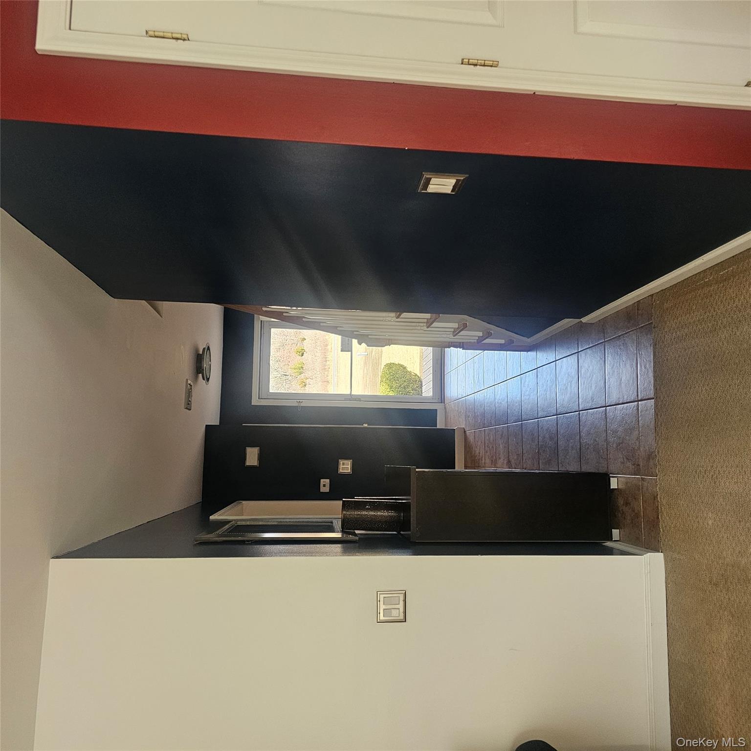 235 Maples Road Middletown, NY 10940 - Photo 25 of 34 Corridor with dark tile patterned floors and dark colored carpet