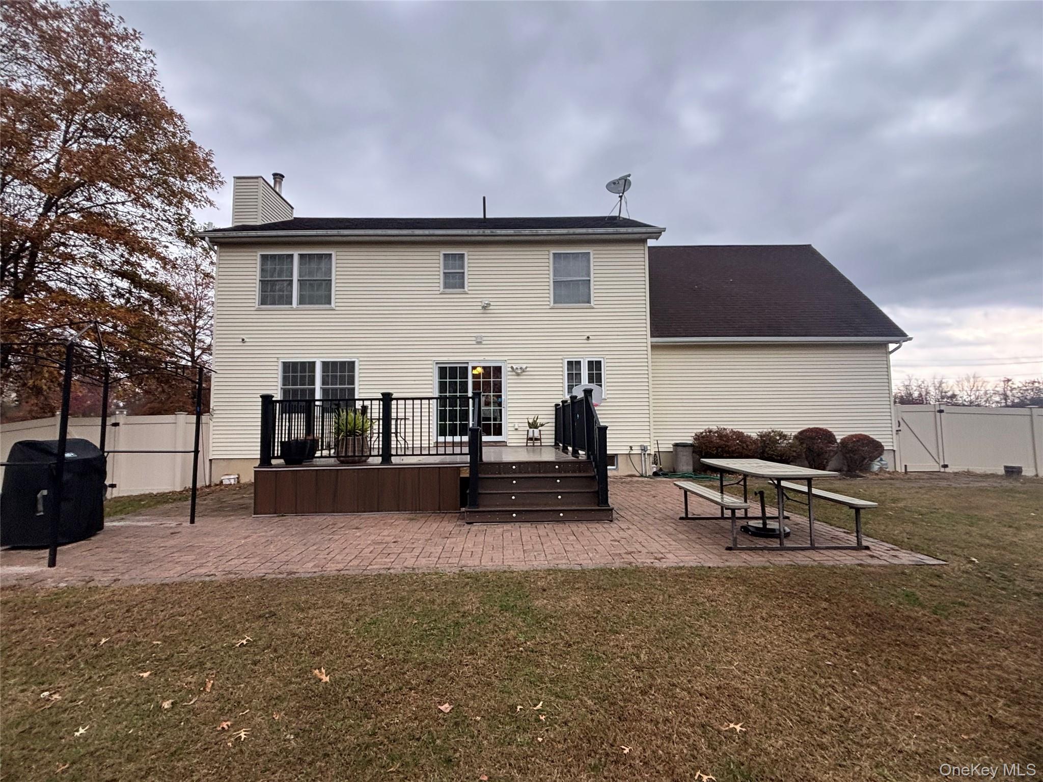 235 Maples Road Middletown, NY 10940 - Photo 31 of 34 Rear view of house featuring a patio, a wooden deck, a fenced backyard, and a chimney