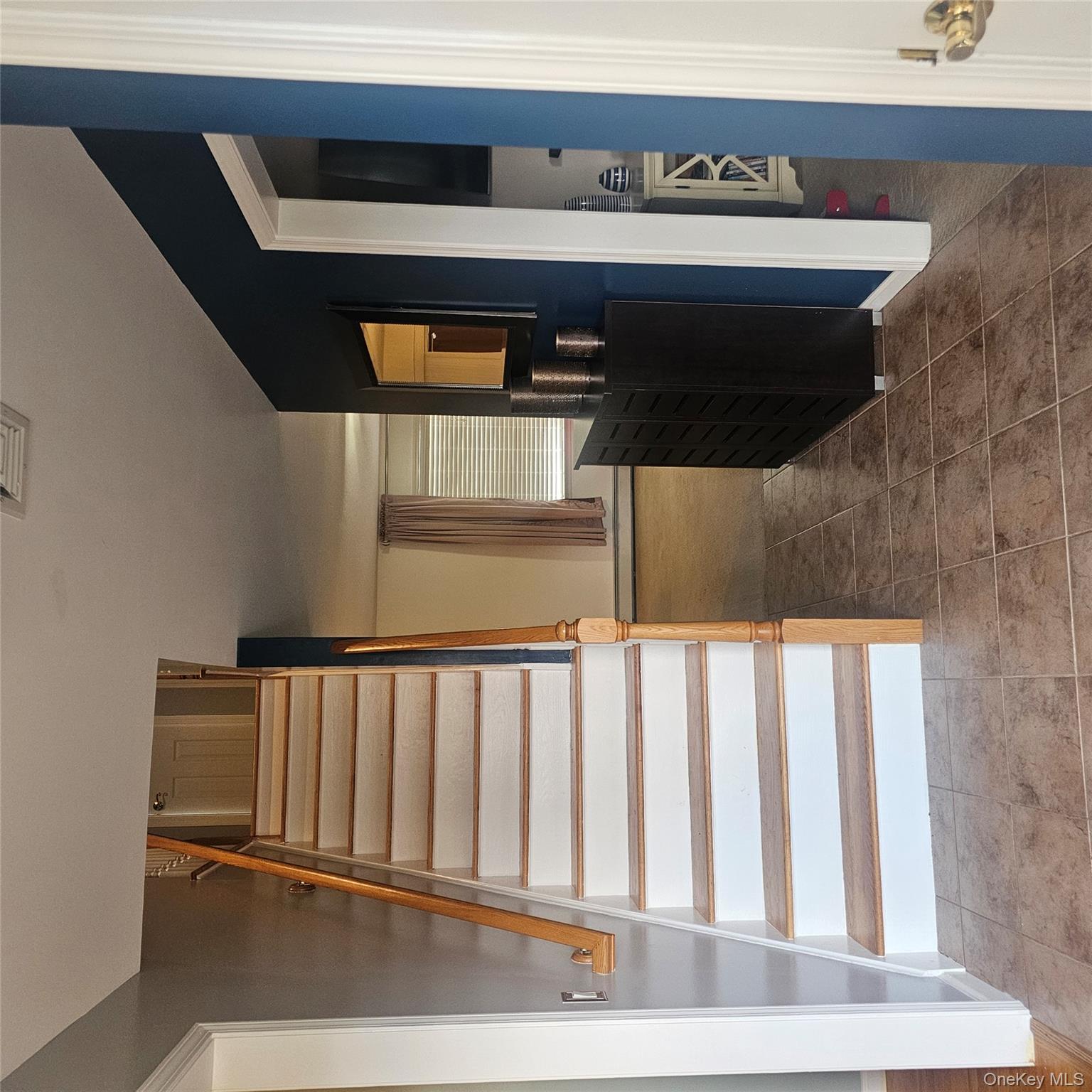 235 Maples Road Middletown, NY 10940 - Photo 5 of 34 Stairway with tile patterned flooring and a baseboard radiator