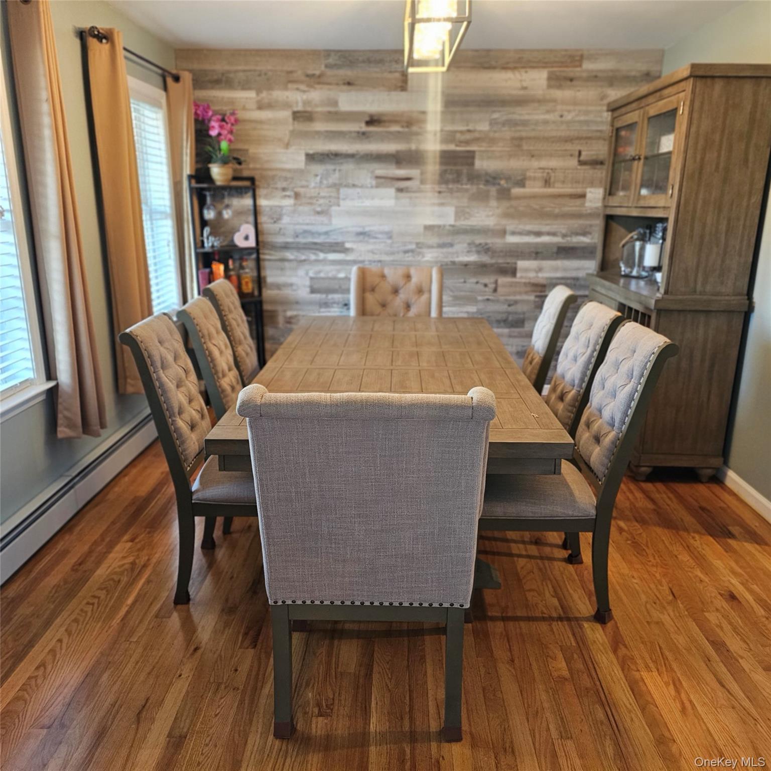 235 Maples Road Middletown, NY 10940 - Photo 6 of 34 Dining space with wood walls, wood finished floors, and a baseboard heating unit