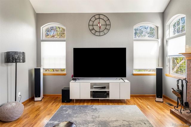 a living room with a flat screen tv and a fireplace