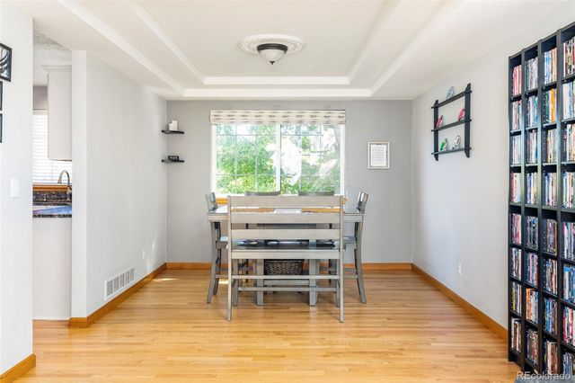a dining room with furniture window and wooden floor