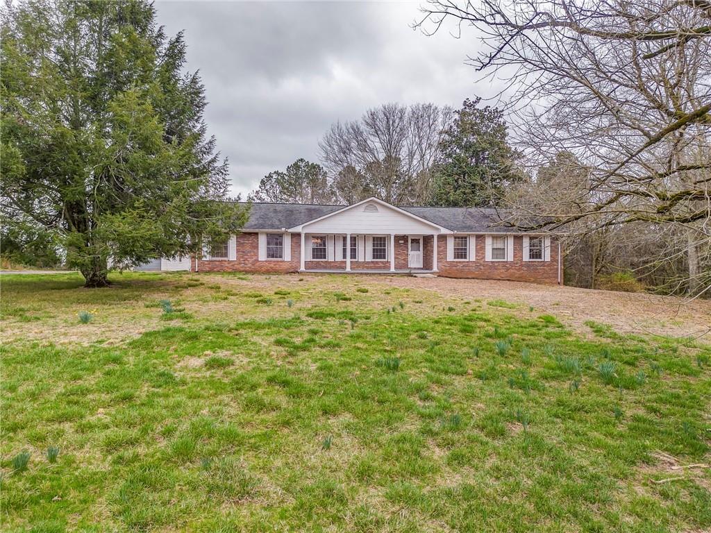 1065 Cartersville Street Ball Ground, GA 30107 - Photo 1 of 51 a view of a house with yard and sitting area