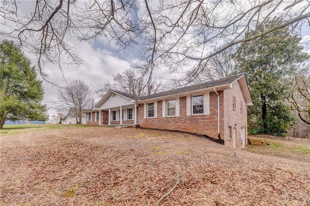 1065 Cartersville Street Ball Ground, GA 30107 - Photo 13 of 51 a view of a yard in front of a house with large trees