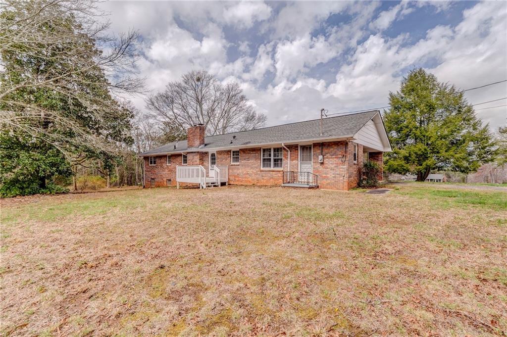 1065 Cartersville Street Ball Ground, GA 30107 - Photo 17 of 51 a house view with a yard