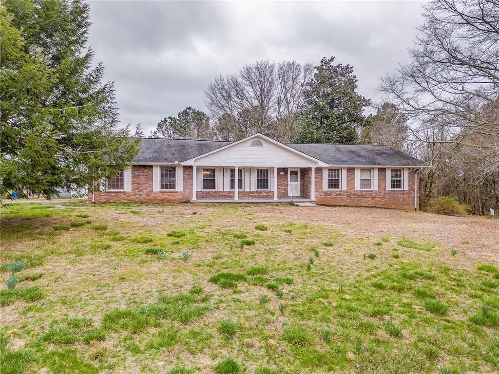 1065 Cartersville Street Ball Ground, GA 30107 - Photo 2 of 51 a front view of a house with a yard