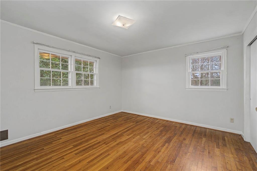 1065 Cartersville Street Ball Ground, GA 30107 - Photo 22 of 51 a view of empty room with wooden floor and fan