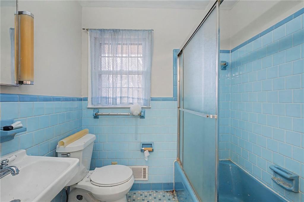 1065 Cartersville Street Ball Ground, GA 30107 - Photo 25 of 51 a bathroom with a sink a toilet and a mirror