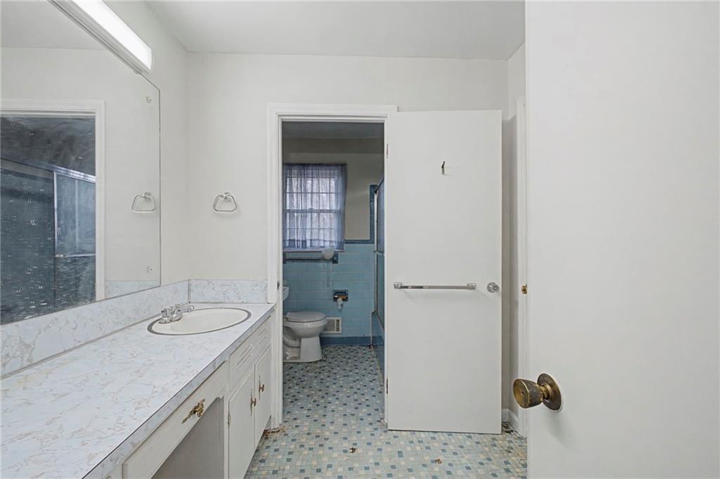 1065 Cartersville Street Ball Ground, GA 30107 - Photo 26 of 51 a bathroom with a sink a toilet and shower
