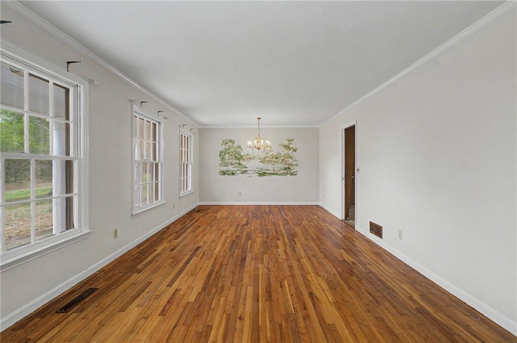 1065 Cartersville Street Ball Ground, GA 30107 - Photo 35 of 51 wooden floor in an empty room with a window