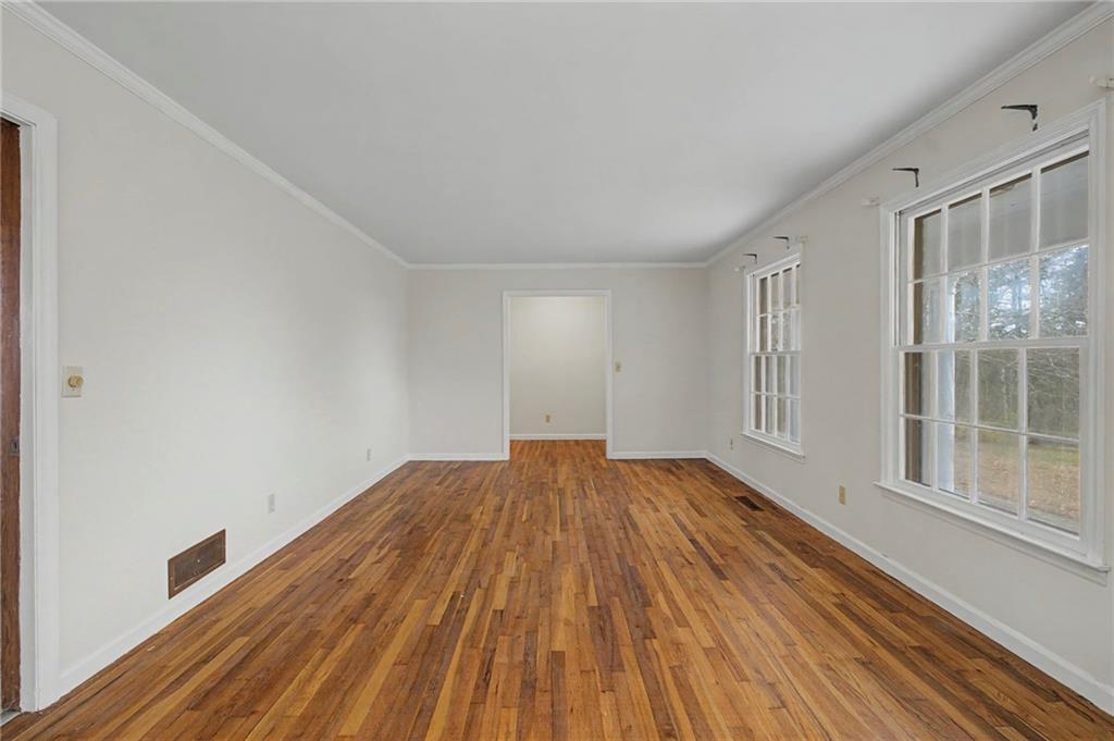 1065 Cartersville Street Ball Ground, GA 30107 - Photo 37 of 51 a view of empty room with wooden floor and fan