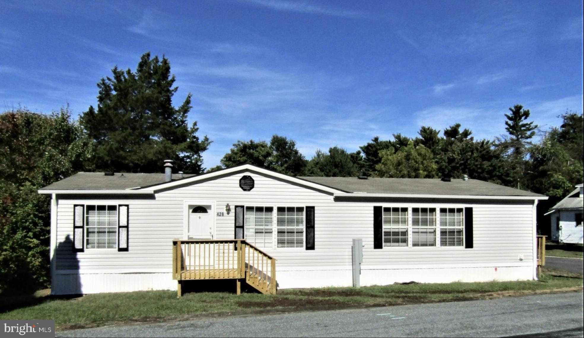 a view of a white house with a yard