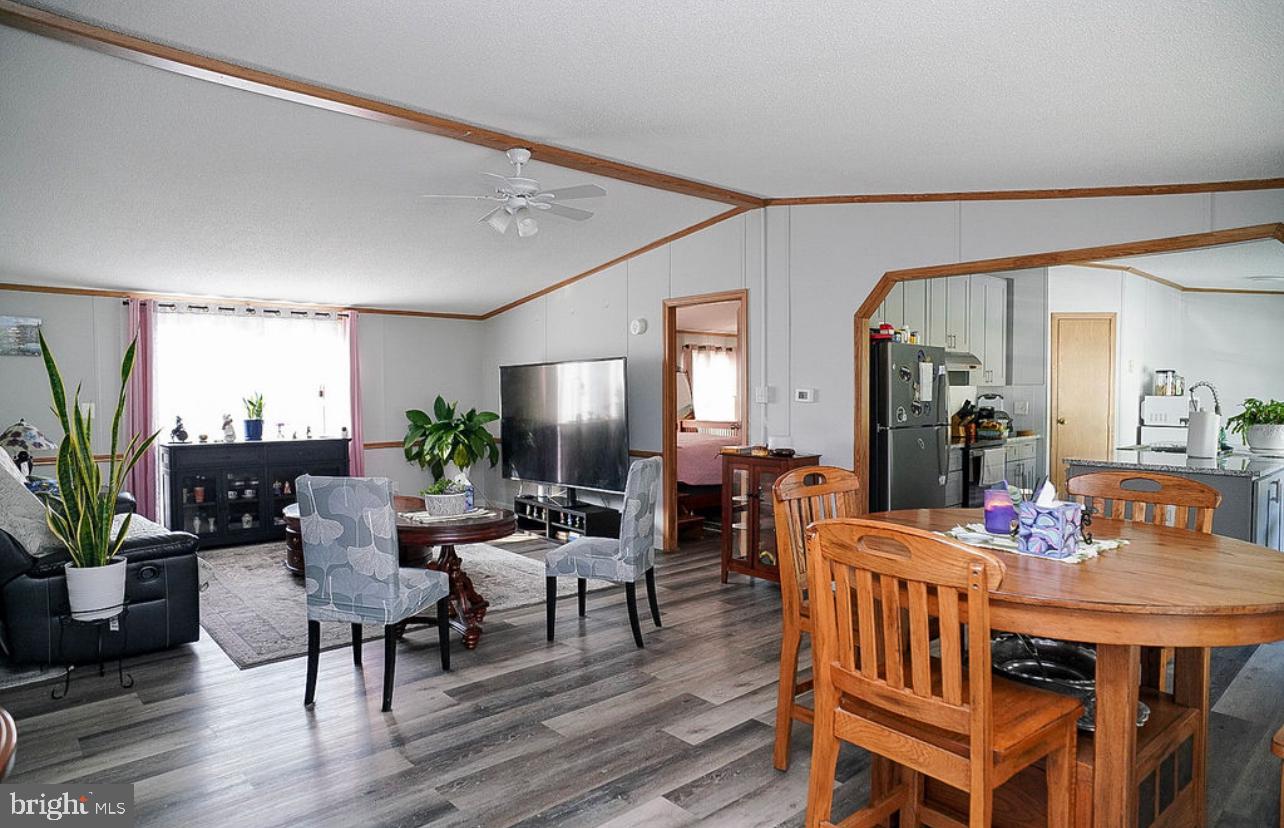 428 Pollack Drive Perryman, MD 21130 - Photo 2 of 13 a dining room with furniture potted plants and wooden floor