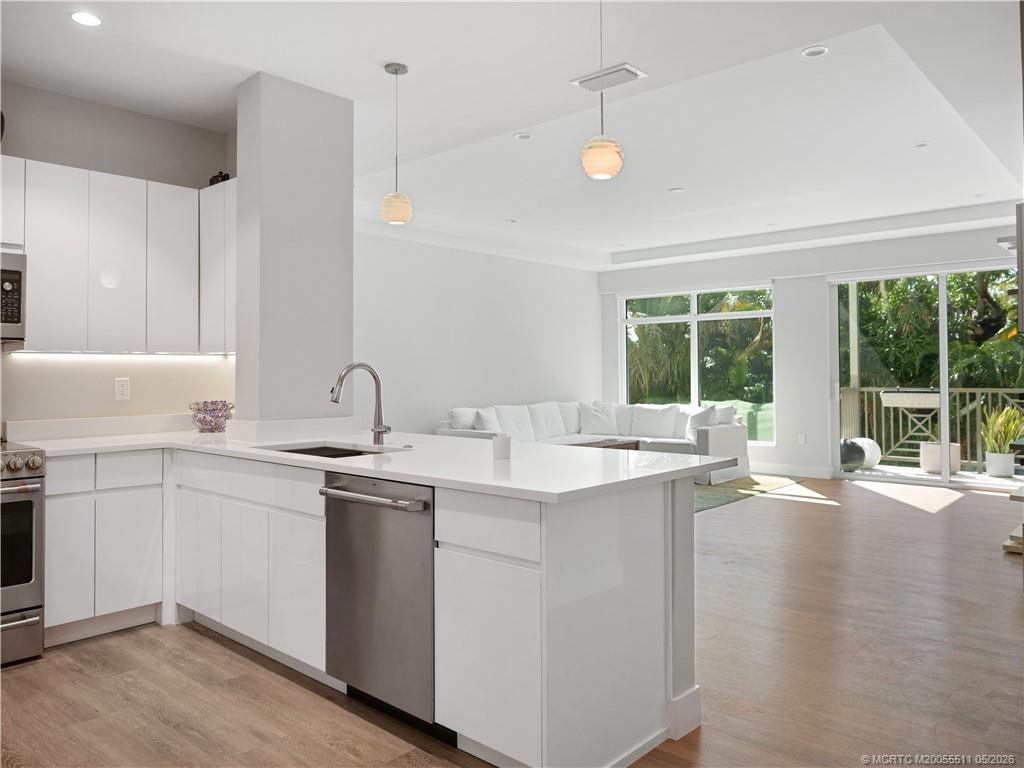 41 Southwest Seminole Street, Unit 208 Stuart, FL 34994 - Photo 7 of 46 a kitchen with a sink and large window