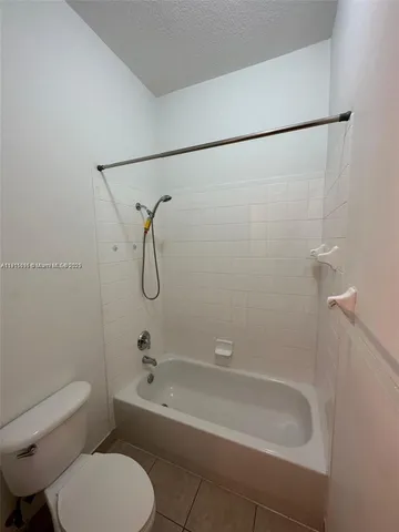 a bathroom with a toilet and a bath tub