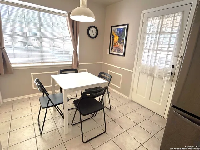 a view of a dining room with furniture and a window