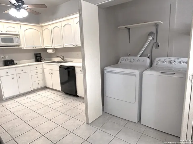 a kitchen with a stove top oven sink and cabinets