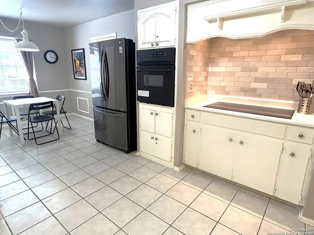 a kitchen with stainless steel appliances a refrigerator and a stove