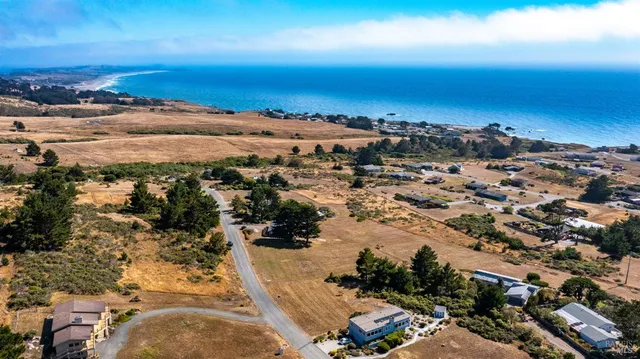 an aerial view of residential building and ocean view