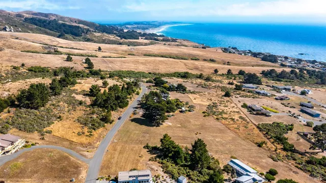 a view of a field with an ocean view