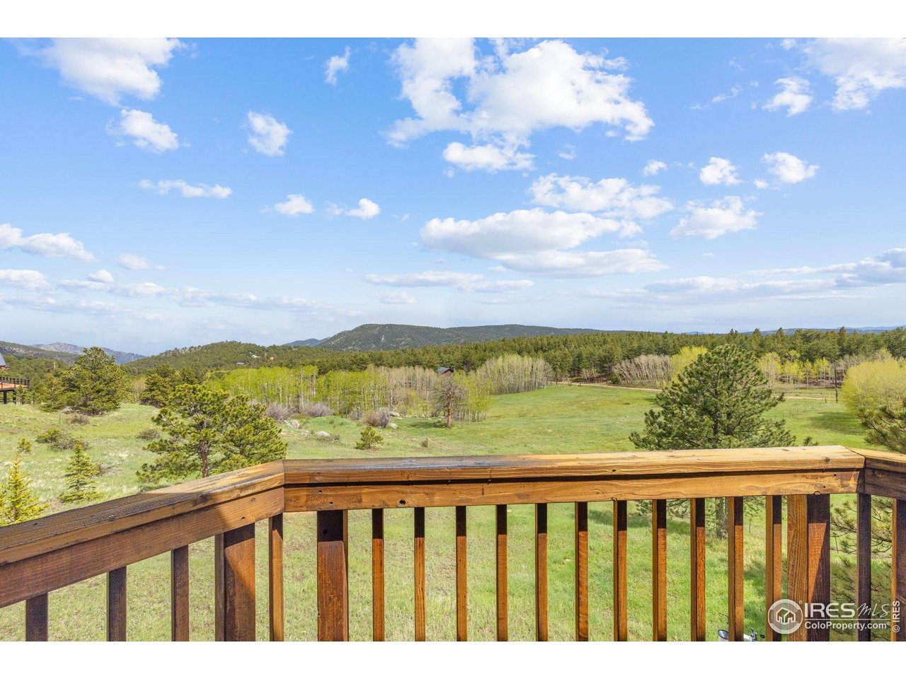 1117 Rock Lake Road Ward, CO 80481 - Photo 21 of 40 a view of city and mountain from a balcony