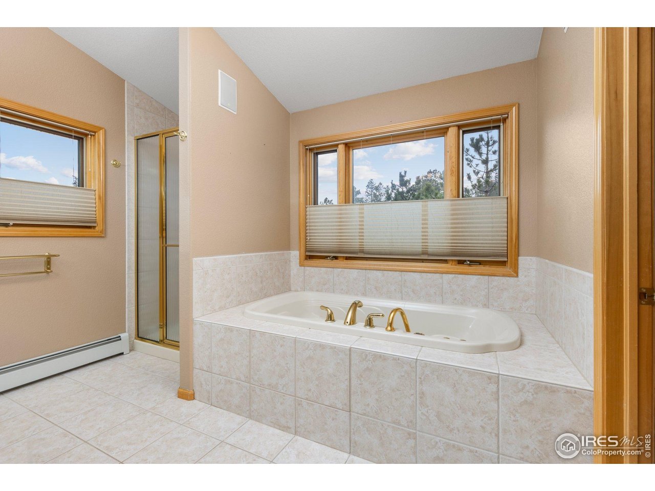 1117 Rock Lake Road Ward, CO 80481 - Photo 23 of 40 a bathroom with a tub a sink and mirror