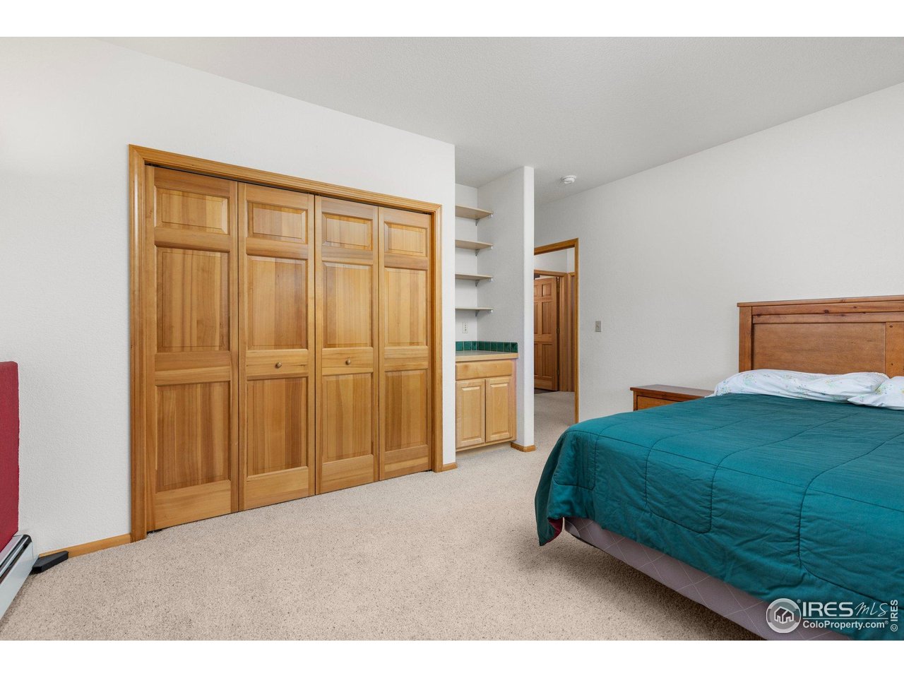 1117 Rock Lake Road Ward, CO 80481 - Photo 29 of 40 a bedroom with a bed and a cabinet
