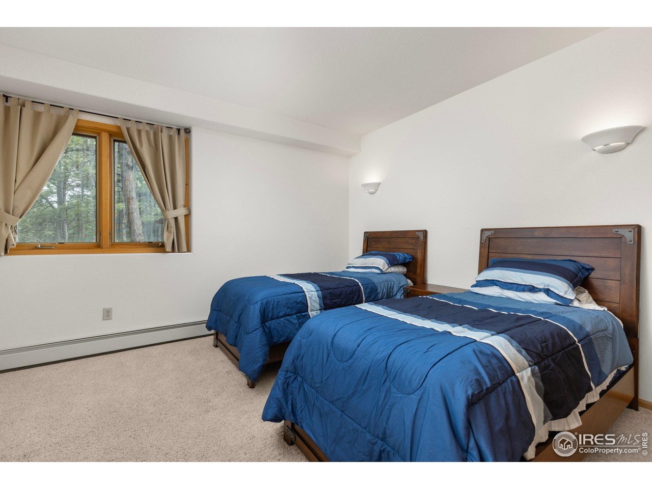 1117 Rock Lake Road Ward, CO 80481 - Photo 30 of 40 a bedroom with two beds and a window