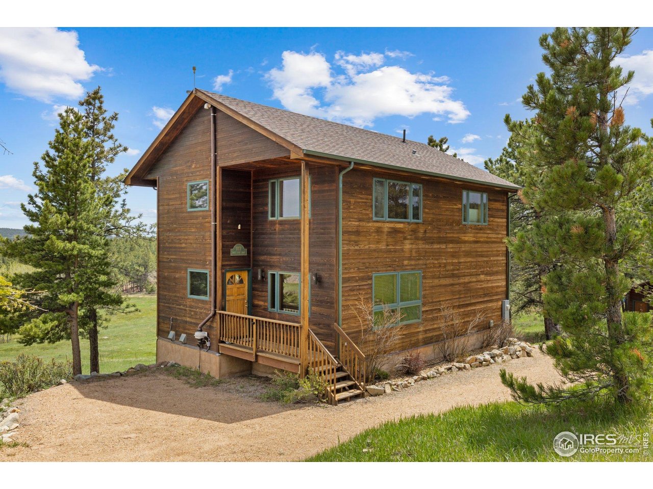 1117 Rock Lake Road Ward, CO 80481 - Photo 7 of 40 a backyard of a house with table and chairs