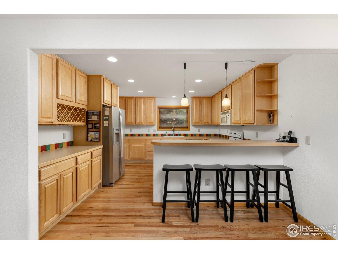 1117 Rock Lake Road Ward, CO 80481 - Photo 8 of 40 a kitchen with stainless steel appliances kitchen island granite countertop a table chairs sink and cabinets