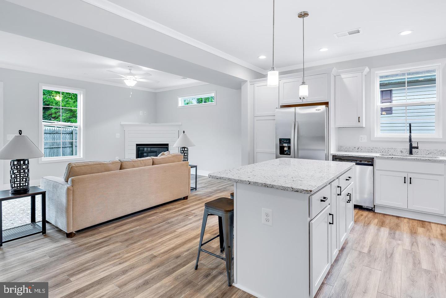 404 Paradise Road Riva, MD 21140 - Photo 11 of 51 a large white kitchen with a stove a sink a window and wooden floor