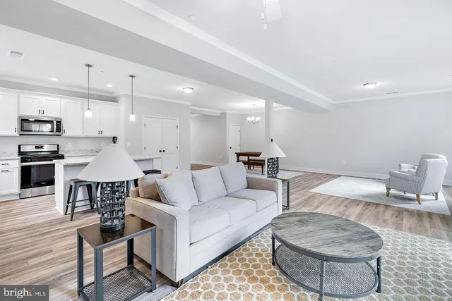 a living room with furniture and kitchen view