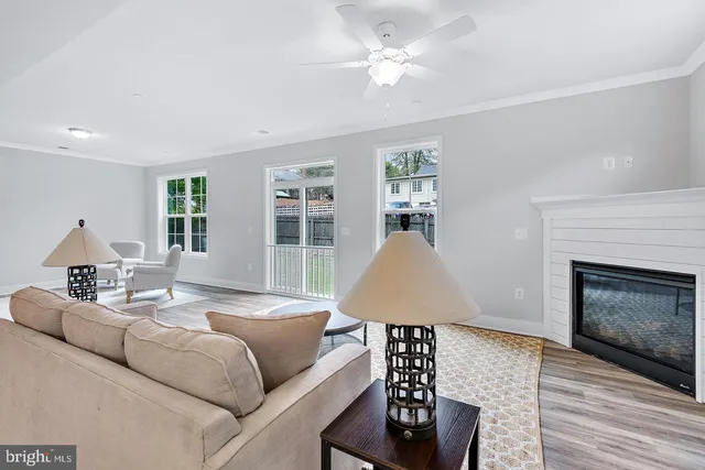 a living room with furniture a fireplace and wooden floor