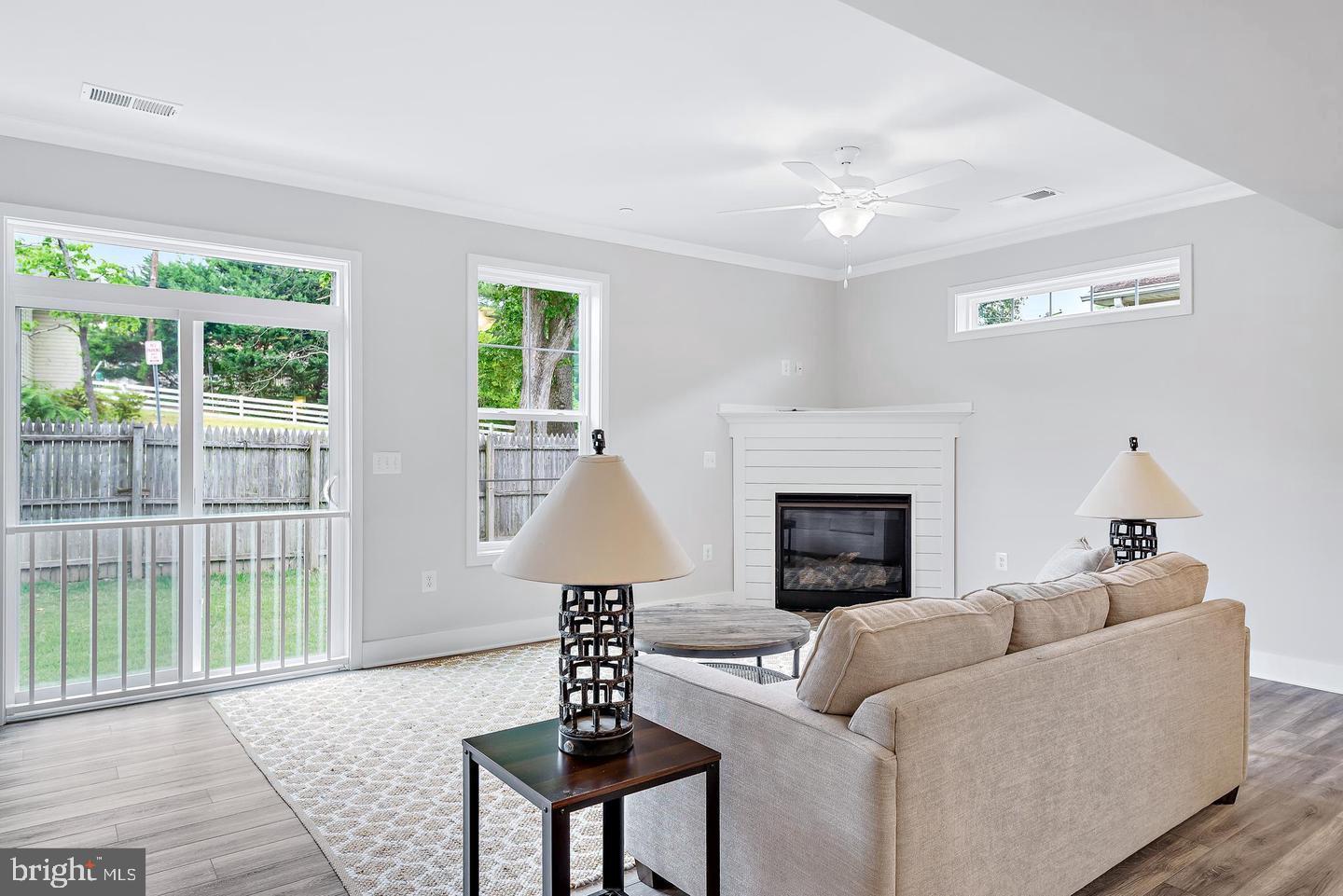 404 Paradise Road Riva, MD 21140 - Photo 16 of 51 a living room with furniture a fireplace and a floor to ceiling window