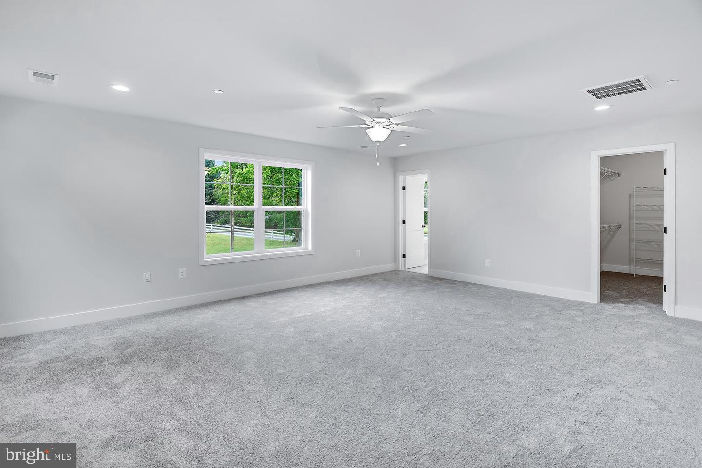 404 Paradise Road Riva, MD 21140 - Photo 23 of 51 an empty room with windows closet and chandelier fan