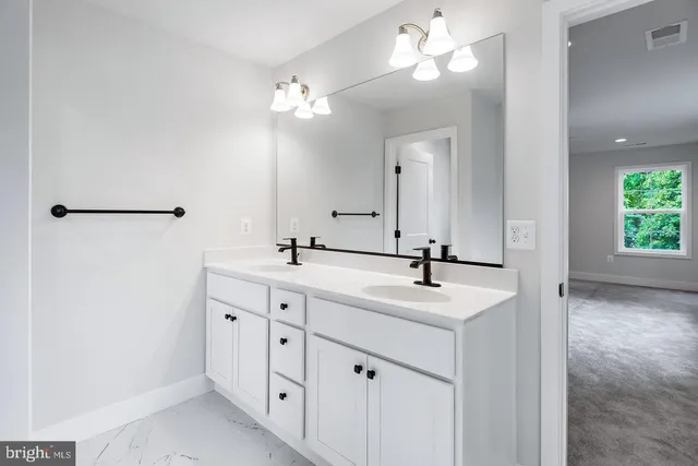 a bathroom with a sink vanity and a mirror