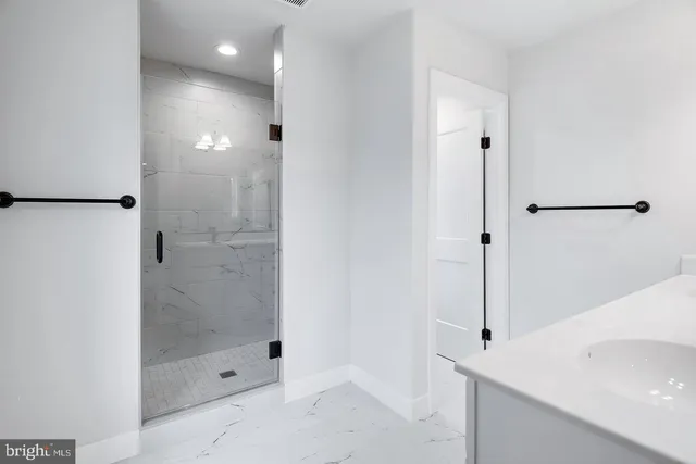 a bathroom with a shower and a sink