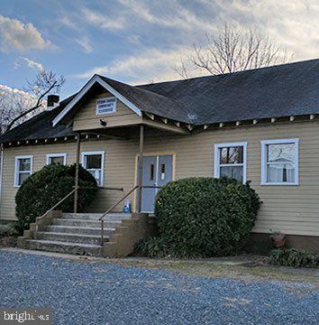 404 Paradise Road Riva, MD 21140 - Photo 42 of 51 a front view of a house with garden