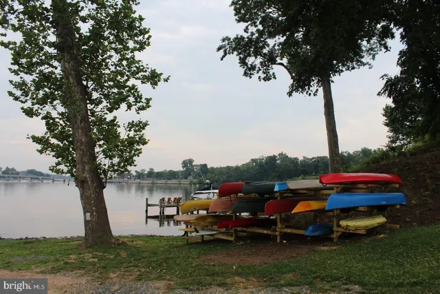 a view of a lake with a table and chairs