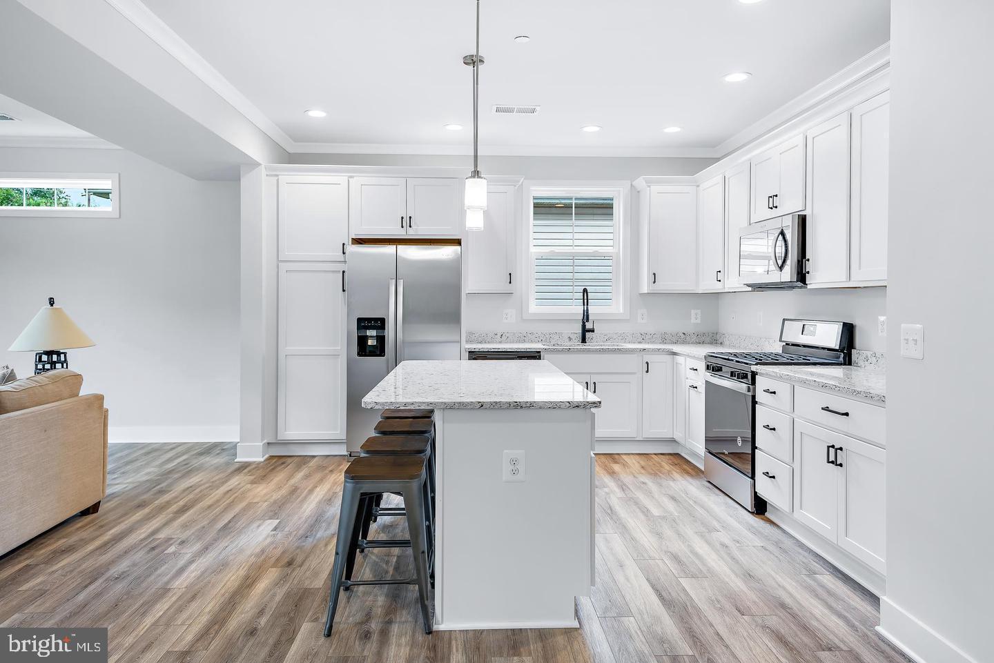 404 Paradise Road Riva, MD 21140 - Photo 7 of 51 a kitchen with a refrigerator a sink and wooden floor