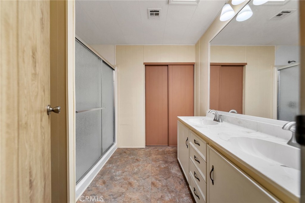 1195 La Moree Road, Unit 36 San Marcos, CA 92078 - Photo 20 of 47 a bathroom with a double vanity sink and mirror