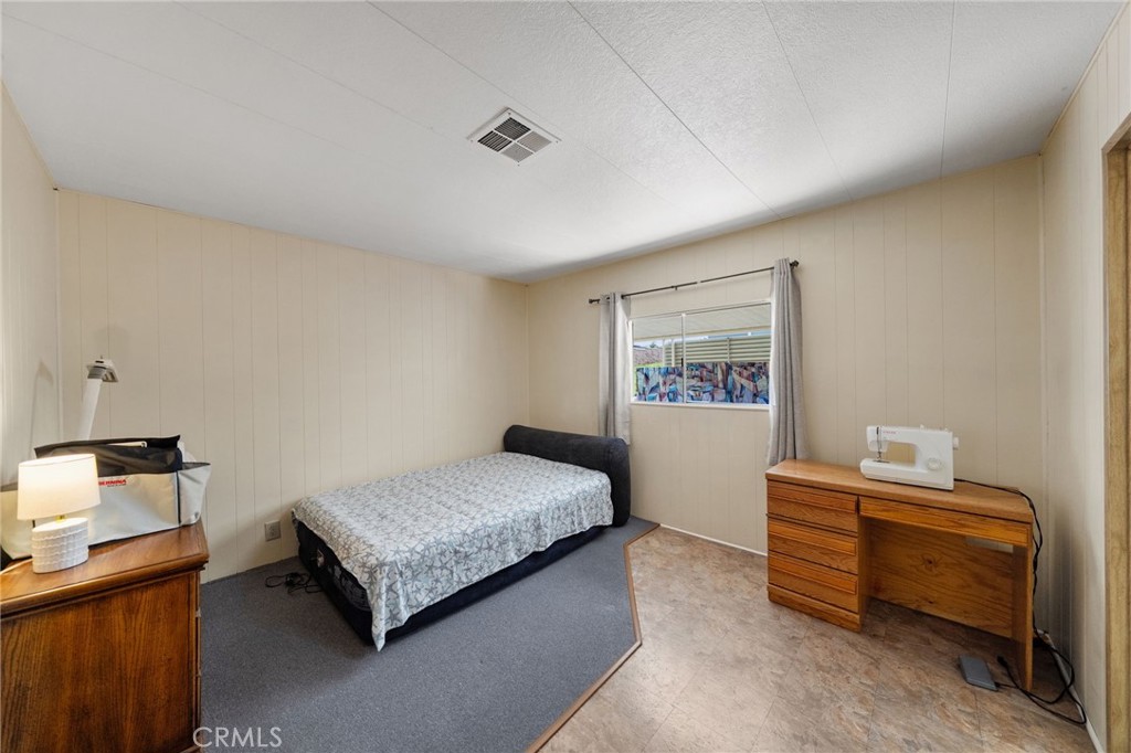1195 La Moree Road, Unit 36 San Marcos, CA 92078 - Photo 22 of 47 a bedroom with a bed and a lamp on the dresser