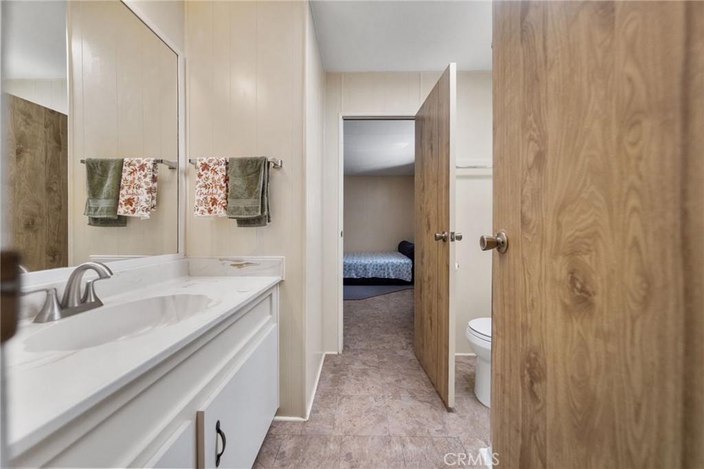 1195 La Moree Road, Unit 36 San Marcos, CA 92078 - Photo 25 of 47 a bathroom with a sink and mirror with toilet