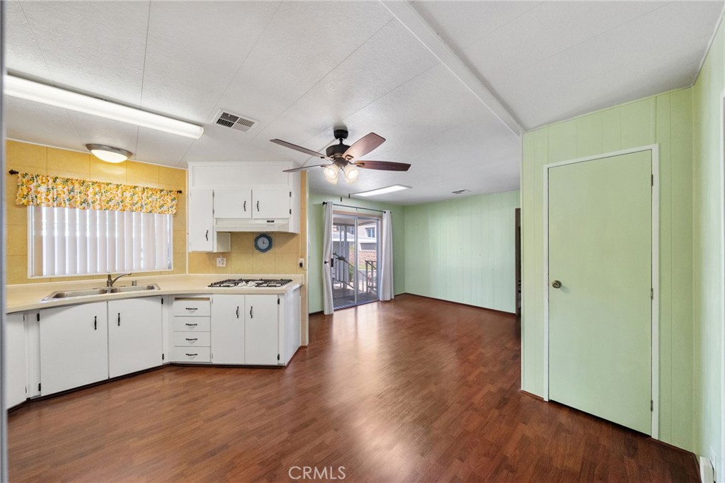 1195 La Moree Road, Unit 36 San Marcos, CA 92078 - Photo 26 of 47 a large kitchen with granite countertop a large window a sink and stainless steel appliances