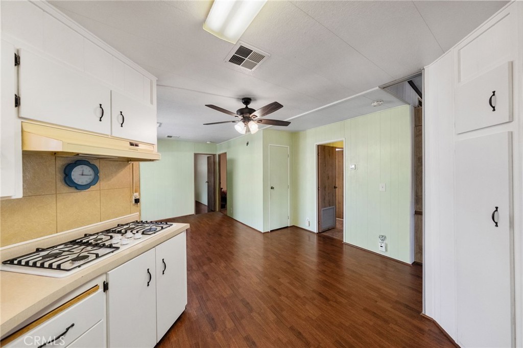 1195 La Moree Road, Unit 36 San Marcos, CA 92078 - Photo 27 of 47 a view of an empty room with window cabinet a ceiling fan and wooden floor